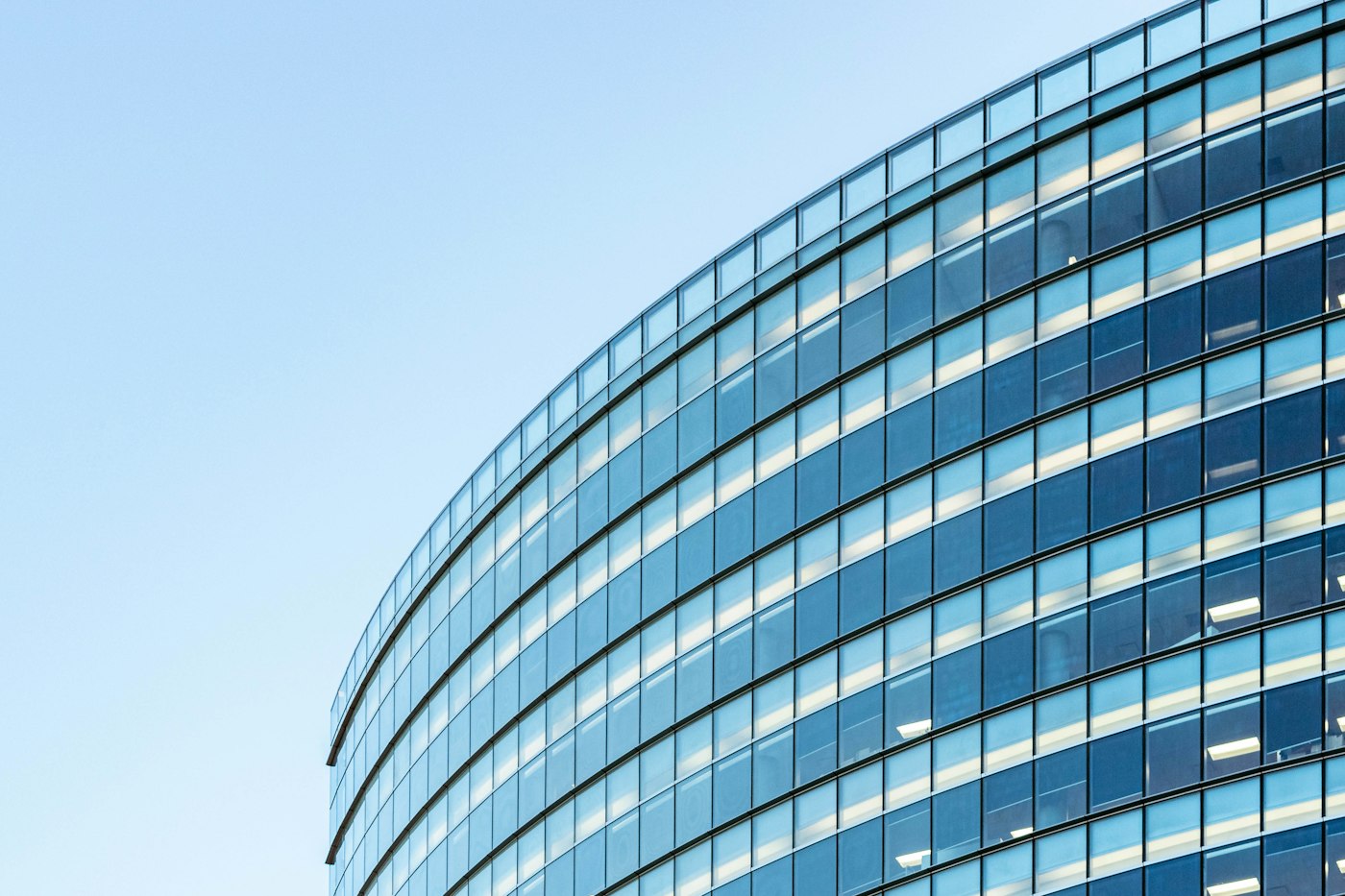 Curved glass curtain-wall office building facade, generic illustrative photo