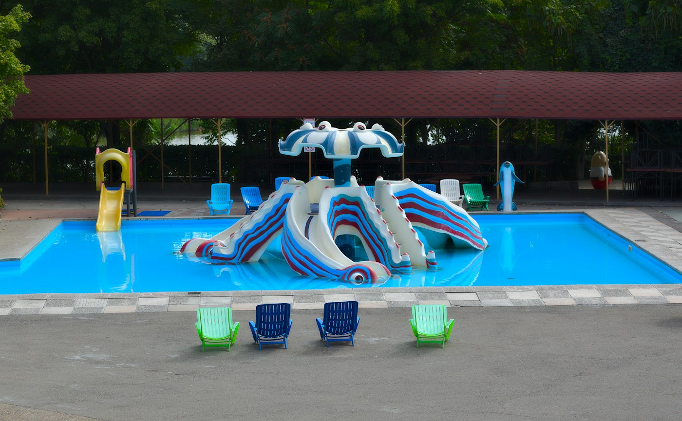 Shallow kids&rsquo; pool with a poolside play structure, generic illustrative photo