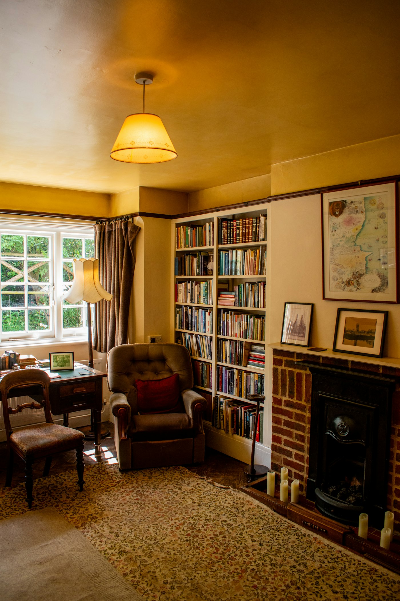 Cosy reading corner with an armchair and bookshelf, generic illustrative photo